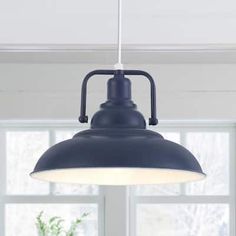 an industrial style light hanging over a dining room table