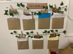 a bulletin board with notes attached to it and ivy growing on the wall next to it