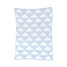 a blue and white pillow with clouds on it