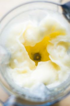 an overhead view of a blender filled with yogurt