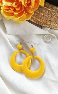 Yellow hoop vintage earrings , vintage jewellery , 40 s, 50 s style earrings , pin up jewellery, roockabilly earrings , yellow hoop earrings,  This fabulous jewellery are handmade by me, in the style of a 1940 ' s 50 's novelty bakelite brooch design. This eye catching earrings will finish off your perfect wardrobe and look amazing !   Perfect for every  styling.   Earrings measures  7  cm length and 4.5 cm across. All my things  are done with care for every detail. If you have a question don 't hesitate to ask! The colour may vary depending on the monitor settings Retro Jewelry For Parties, Party Jewelry With Yellow Ear Wire, Handmade Vintage Hoop Earrings For Summer, Yellow Jewelry With Ear Wire For Party, Vintage Drop Earrings For Summer, Vintage Round Earrings For Summer, Vintage Single Earring For Party, Vintage Summer Hoop Earrings, Retro Clip-on Earrings For Party