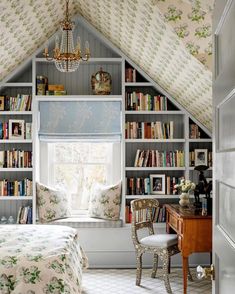 a bedroom with a bed, desk and bookshelf in it's corner