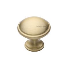 an antique brass cabinet knob on a white background