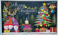 a chalk board with christmas decorations on it