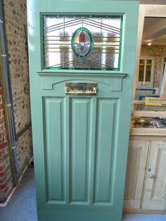 a green door with a glass window in it