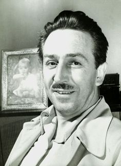 a black and white photo of a man with a mustache