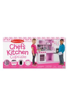 two children standing in front of a kitchen set with the words michael's chef's kitchen cupcake written on it