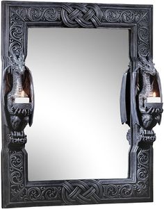 a mirror with an intricate design on the front and sides, hanging from a wall