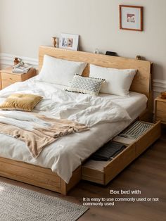 a bed with white sheets and pillows in a bedroom next to a wooden dresser drawer