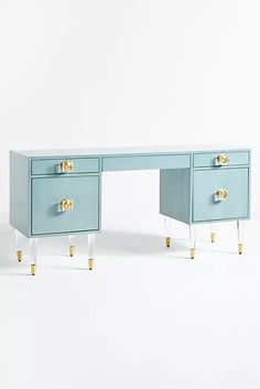 a blue desk with two gold handles on it