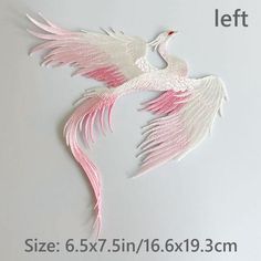 two white birds with pink wings are on the wall