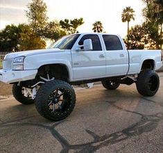 a white truck parked on the side of a road