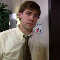 a man wearing a shirt and tie in an office