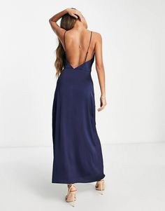 the back of a woman wearing a blue dress with spaghetti straps and low cut neckline