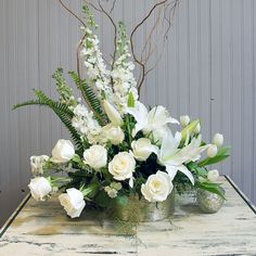 a vase filled with white flowers on top of a table