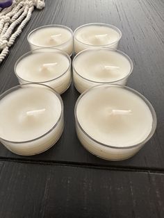 six candles sitting on top of a wooden table