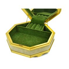 an open green and gold jewelry box on a white background