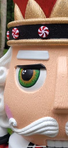 a close up of a statue of a nutcracker with candy canes on it's head