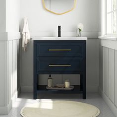 a bathroom with a sink, mirror and rug