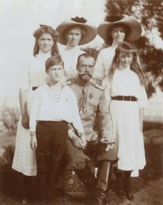 an old black and white photo of a family posing for a group shot with hats on