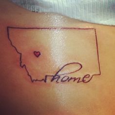 a woman's back with a tattoo that says, home on it and a heart in the middle