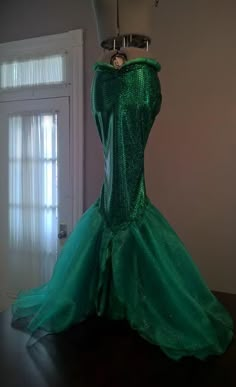 a green dress on display in a room