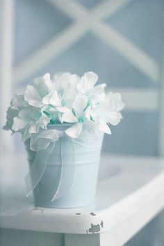 there is a white flower in a green vase on the table with words above it