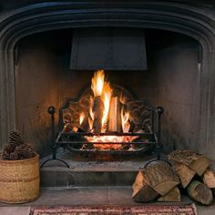 a fire burning in a fireplace with logs