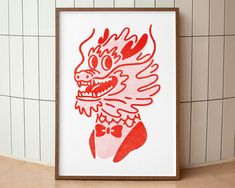 a red and white drawing of a dragon on a wall next to tiled walls in a bathroom