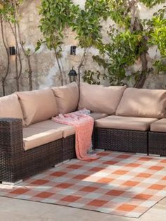 a couch sitting on top of a checkered rug