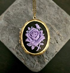 Beautiful black cameo with a dimensional purple rose set in a large antique brass locket paired with antique brass chain.  Details: Pendant measures approx 2.5 inches (6.35cm)  Necklace measures 26 inches (55.88cm) Locket and chain are plated brass Lead and nickel free Want a shorter chain? Just leave a note to seller at checkout for me and I can adjust it for you, no extra charge. Thank you for shopping Delicate Industry :) Purple Locket, Black Cameo, Large Locket, Rose Violette, Necklace Flower, Holiday Gift Ideas, Cameo Necklace, Purple Rose, Purple Roses