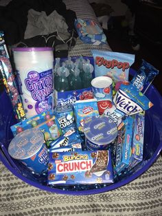 a blue bowl filled with candy and snacks