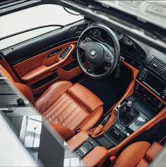 the interior of a sports car with leather seats and dashboard, including an automatic steering wheel