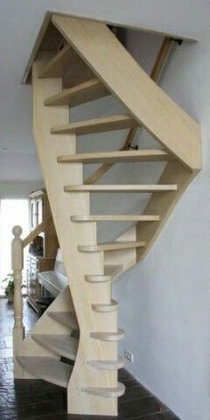 a wooden spiral staircase in a house