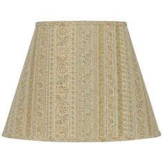 a lamp shade that is on top of a white table cloth with an ornate pattern