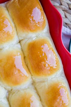 a red dish filled with bread on top of a table