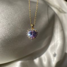 Add a touch of regal elegance to your jewelry collection with this Purple Royal Heart Necklace. The tiny violet halo pendant is made of non-tarnish 925 sterling silver, making it a durable and affordable choice for a love-themed gift. The purple color adds a touch of whimsy and femininity to any outfit, making it perfect for any occasion. Whether you're dressing up for a night out or just want to add a pop of color to your everyday look, this Purple Royal Heart Necklace is the perfect choice. Bu Purple Heart Cut Sterling Silver Necklace, Purple Heart-cut Sterling Silver Necklace, Purple Sterling Silver Heart Cut Necklace, Purple Heart Pendant Necklace For Formal Occasions, Purple Sterling Silver Heart Pendant Necklace, Purple Heart Necklace For Anniversary, Sterling Silver Purple Heart Pendant Necklace, Elegant Heart-shaped Amethyst Necklace, Formal Purple Heart Pendant Necklace