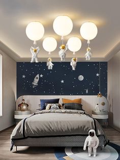 a bed room with a neatly made bed and space themed wallpaper on the walls