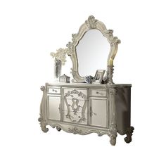 an ornate white dresser with mirror and drawers