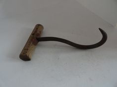 a wooden hook with a ruler attached to it