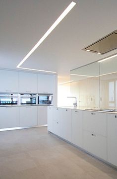 an empty kitchen with white cabinets and counter tops, is shown in this image from the inside