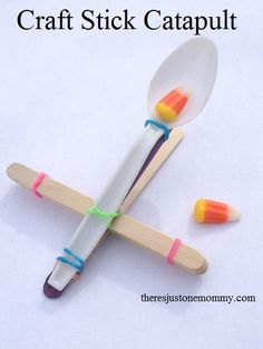 two toothbrushes sitting on top of each other with the words craft stick catapult above them