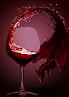 red wine being poured into a glass in front of a dark background with water splashing on it