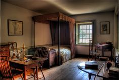 an old fashioned bedroom with four poster bed