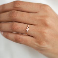 a woman's hand with a diamond ring on it