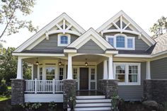 a gray house with white trim and windows