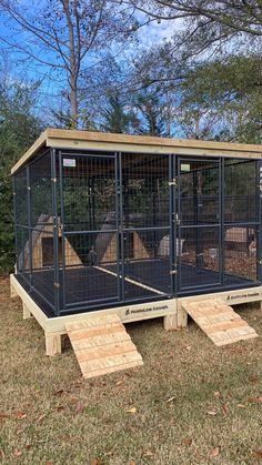 a caged in area with steps leading up to the top and side doors open