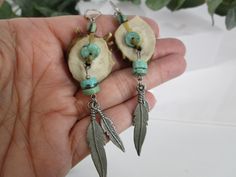 Turquoise and Deer Antler Dangle Earrings. Beautiful and quite different antler and turquoise earrings. Yes, actual deer antlers, made of naturally-shed antler bone, carved and polished smooth. No deer were harmed! These have a 3 1/4" drop from their sterling silver French wires, easy and secure on/off. Genuine turquoise heishi with silver feathers flowing from each earring. Gorgeous rustic earrings, and can be for either women or men. The wires are stamped 925. Dear Antler, Deer Horn Jewelry, Dear Antlers, Deer Antler Jewelry, Antler Earrings, Feather Earrings Silver, Antler Jewelry, Antler Art, Turquoise Dangle Earrings