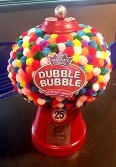 a gummy ball machine sitting on top of a table