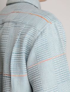 the back view of a woman's shirt with an orange and blue pattern on it